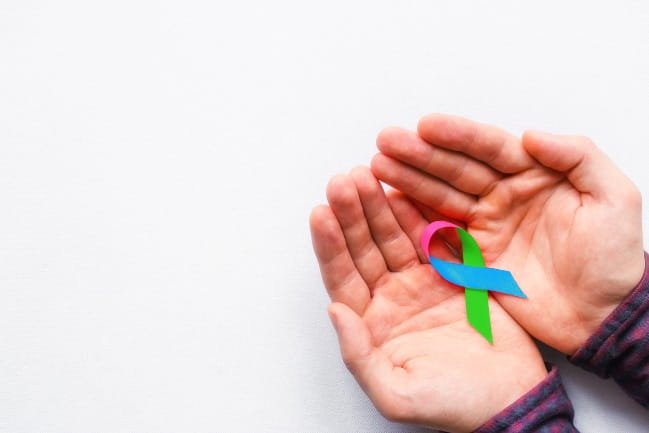 Person holding a rare disease awareness  day ribbon