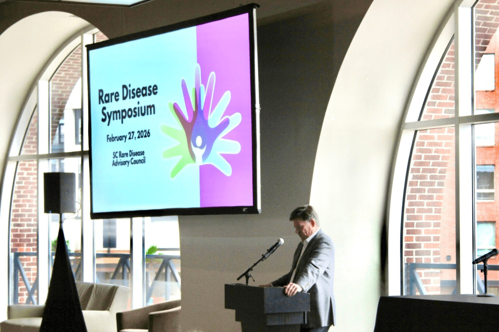 Dr. Patrick Flume standing at the podium during the Rare Disease Symposium